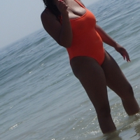 Beach girl in orange swimsuit