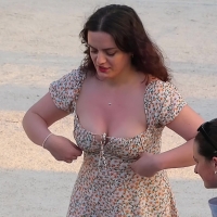 Adjusting her top