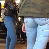 Beautiful sexy girl in tight jeans with friends