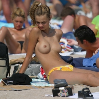 Topless beach babe with great tits