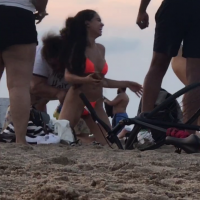 Sexy beach girl in orange thong with great body