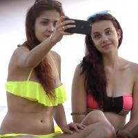 Two beach hotties taking pics